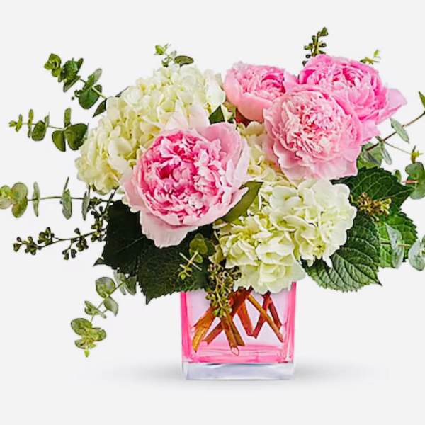 Pink peonies and white hydrangeas in a pink glass vase