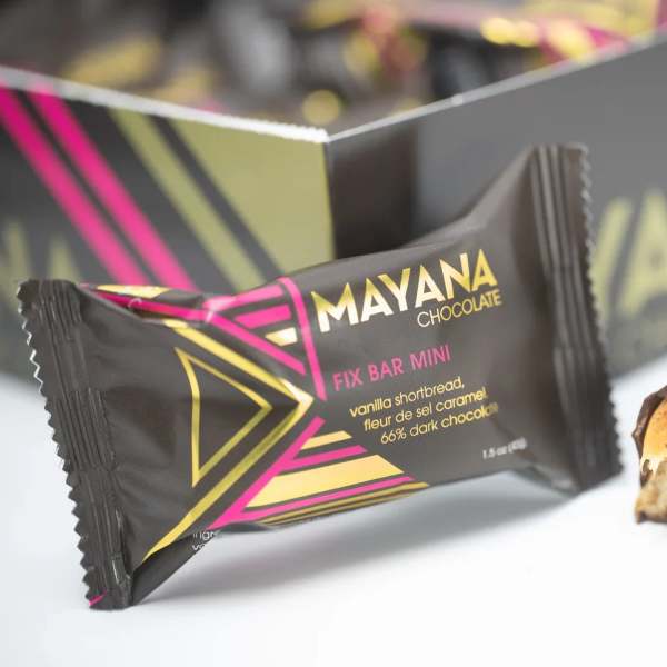 Wrapped chocolate bar with a bitten piece beside it