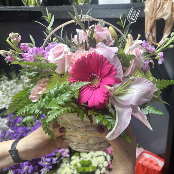 Pink and white mixed bouquet in a woven basket