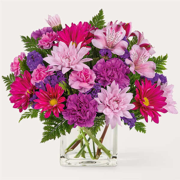 Pink and purple mixed bouquet in a clear glass vase