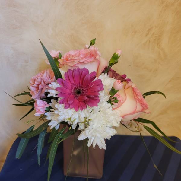 Pink and white mixed bouquet in a brown vase