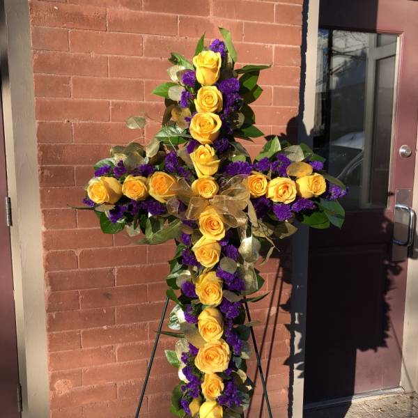 Yellow rose cross on an easel with purple accents