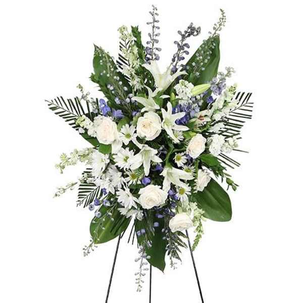 White and blue floral standing spray on an easel