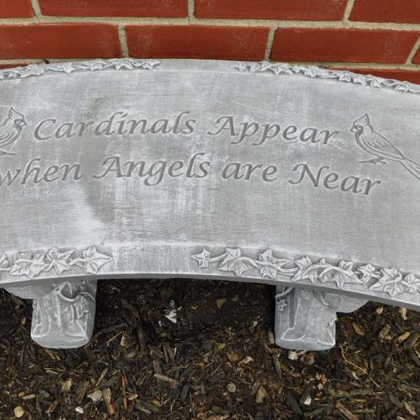 Gray memorial bench with the words Cardinals Appear when Angels are Near
