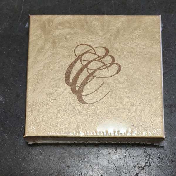 Gold decorative gift box with a brown abstract swirl design