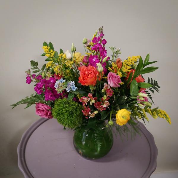Mixed bouquet of colorful flowers in a glass vase