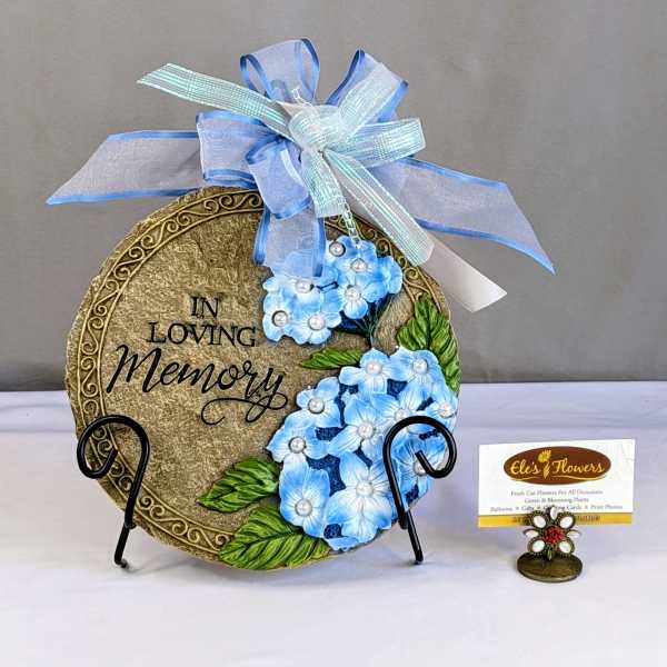 Decorative memorial plaque with blue flowers and ribbon bow