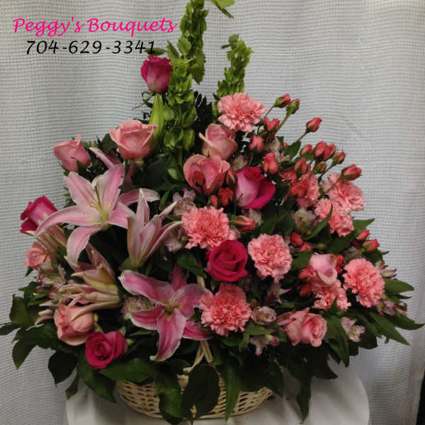 Pink mixed flower basket with roses, lilies, and carnations