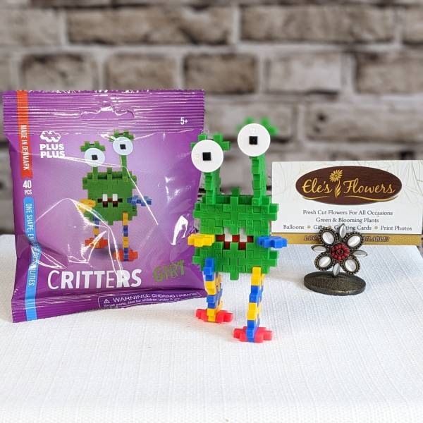 Toy block creature set with a purple package and a small display stand