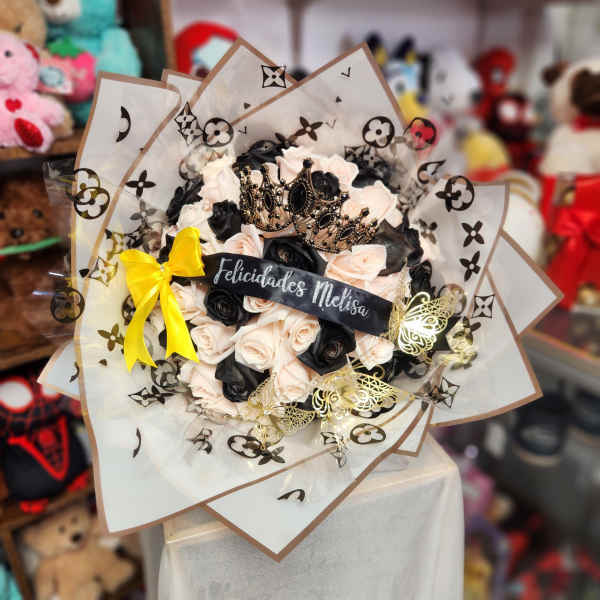 Bouquet of black and blush roses with a crown and yellow ribbon