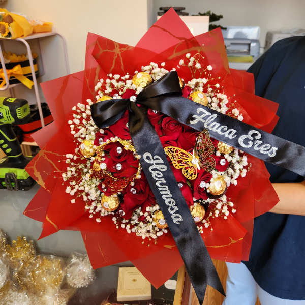 Red rose bouquet with baby’s breath, gold chocolates, and black ribbons
