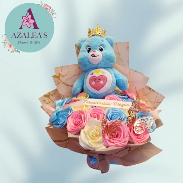 Blue teddy bear with a crown in a bouquet of pastel roses