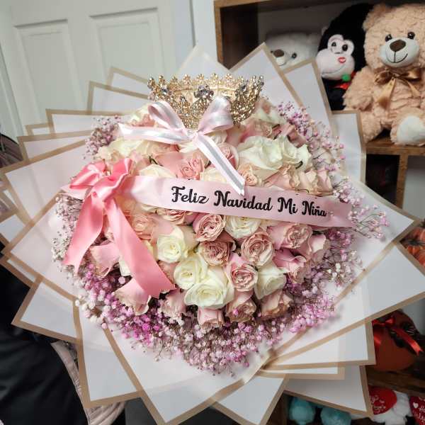 Pink and white rose bouquet with a tiara and ribbon banner