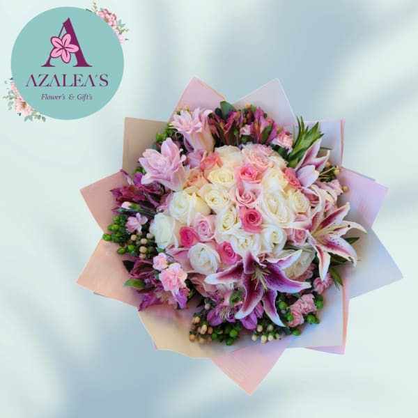 Pink and white rose bouquet with lilies and pastel wrapping