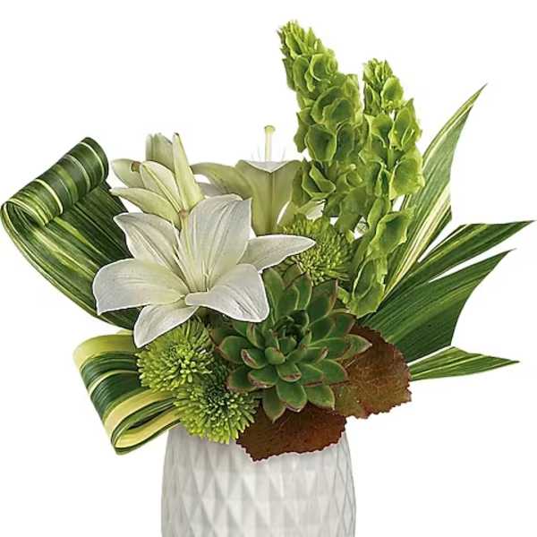 White lilies and green blooms arranged in a white vase