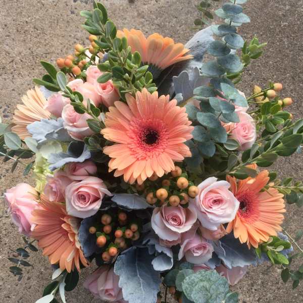 Bouquet of pink roses and peach gerbera daisies with eucalyptus