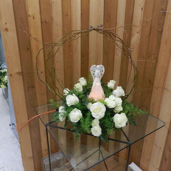White rose arrangement with a decorative angel topper
