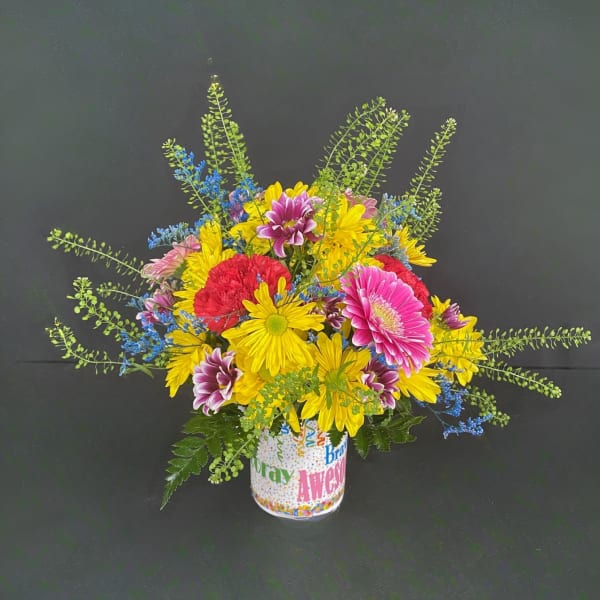 Bright mixed bouquet in a printed mug-style vase
