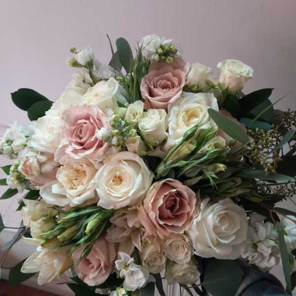 Bouquet of blush and white roses with greenery