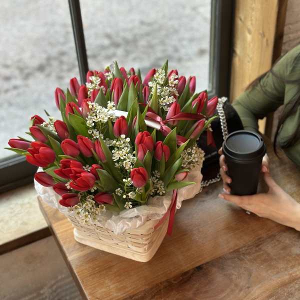 Basket of red tulips with small white filler flowers