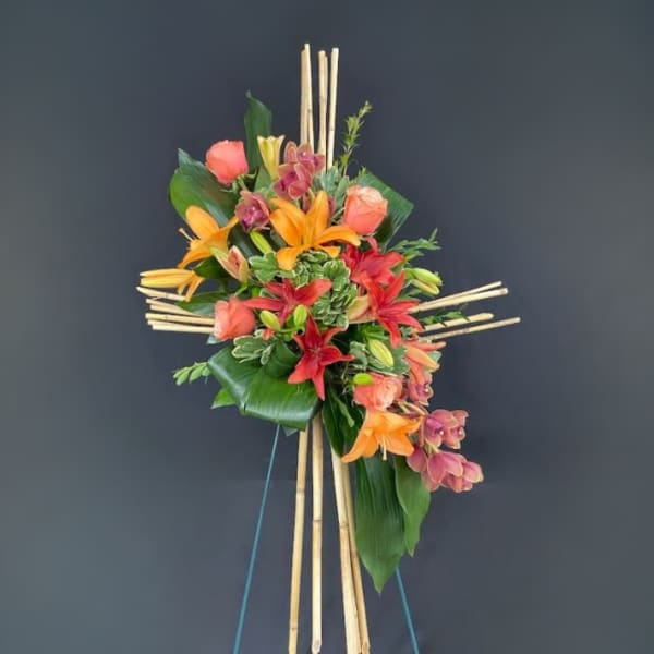 Tropical floral standing spray with lilies and orchids on bamboo