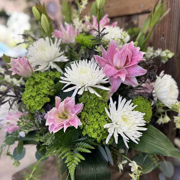 Pink and white floral arrangement with spider mums and lilies