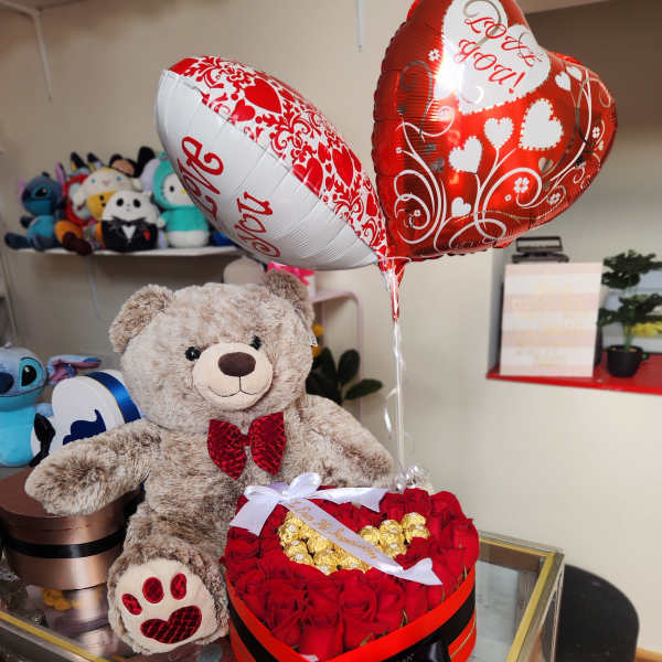 Heart-shaped rose box with teddy bear and Valentine balloons