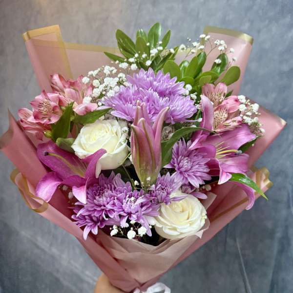 Pink and lavender bouquet with roses, lilies, and chrysanthemums