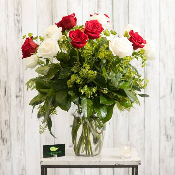 Red and white roses in a clear glass vase