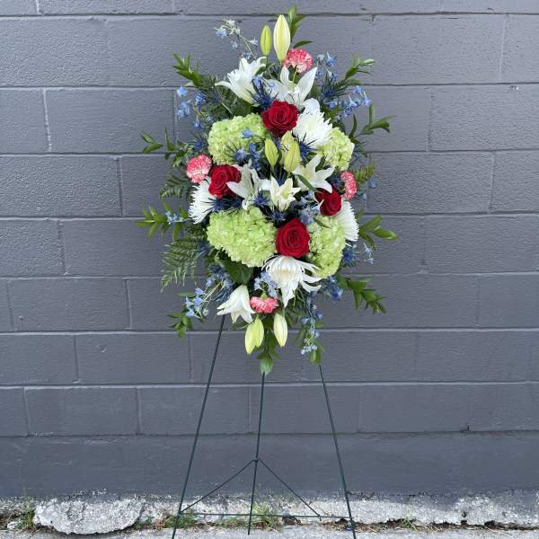 Standing floral spray with red roses, white lilies, and green hydrangeas