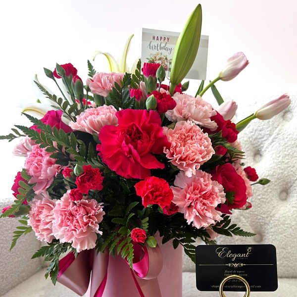 Pink and red carnation bouquet in a pink hatbox with a birthday card