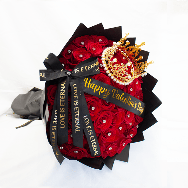 Bouquet of red roses with a decorative crown and black ribbons