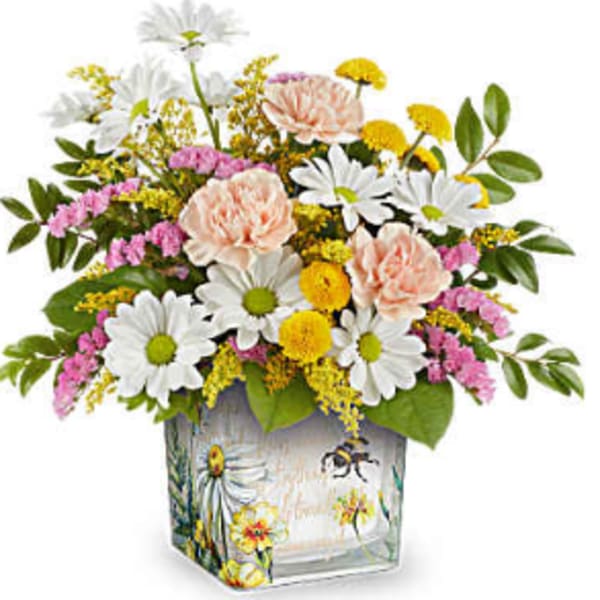 Mixed bouquet of daisies, carnations, and yellow filler flowers in a painted glass vase