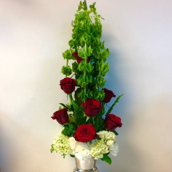Tall red rose arrangement in a silver urn with white hydrangeas