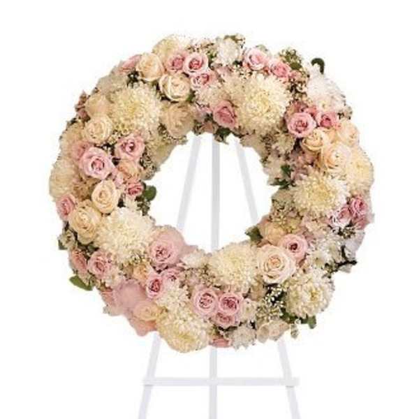 Pastel floral wreath on a white stand