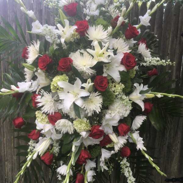 Large standing floral spray with red roses and white lilies