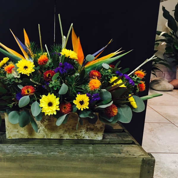 Bright mixed floral arrangement in a rectangular container