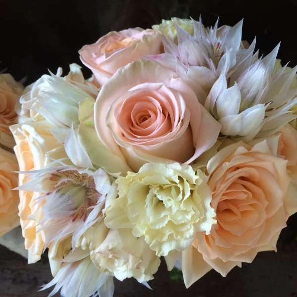 Bouquet of pale peach roses and cream flowers