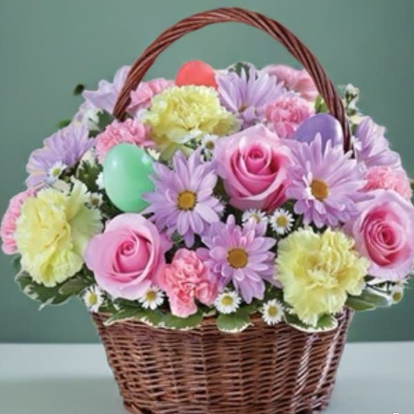 Basket of pastel flowers with roses, daisies, and carnations