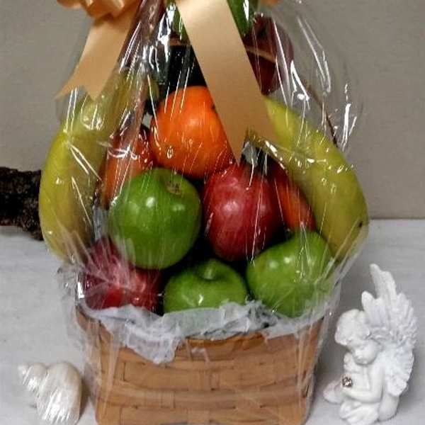 Basket of assorted fruit wrapped in clear cellophane with a large bow