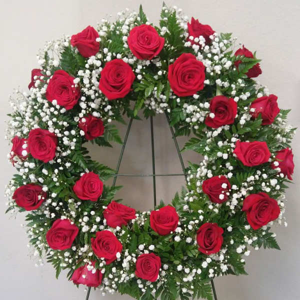 Red rose wreath with white baby's breath on a standing easel
