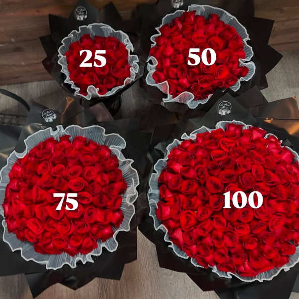 Four bouquets of red roses wrapped in black paper with white ruffles