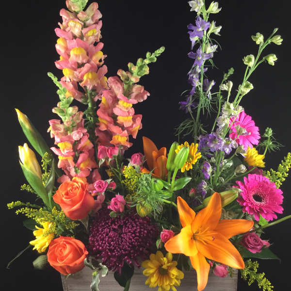 Colorful mixed flower arrangement in a rectangular wooden box