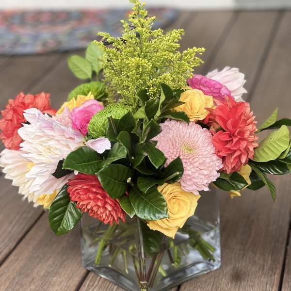 Colorful mixed bouquet in a square glass vase