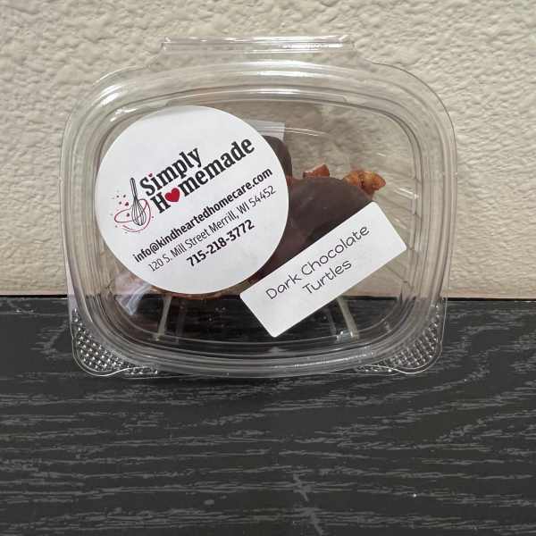 Plastic container of dark chocolate turtles with labels