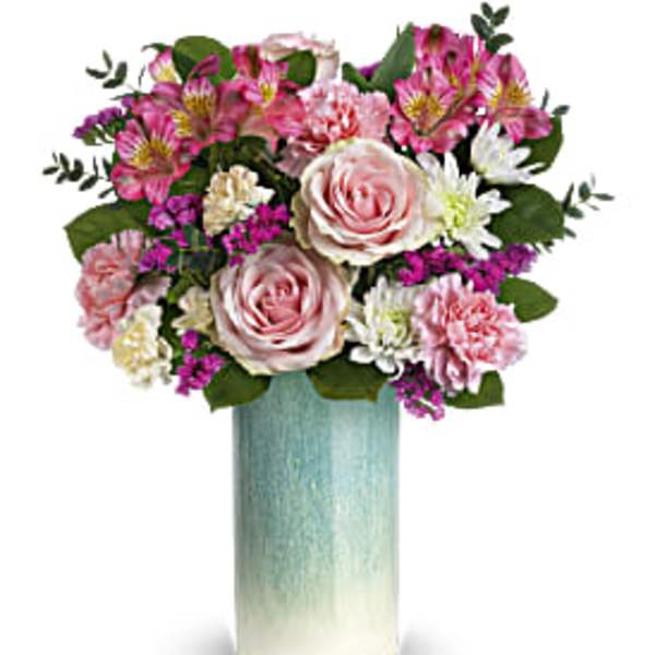 Tall pink and white mixed flower arrangement in a blue ombre cylinder vase