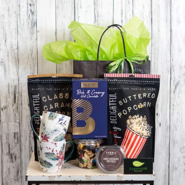 Gift basket with mugs, popcorn, hot chocolate, and chocolates