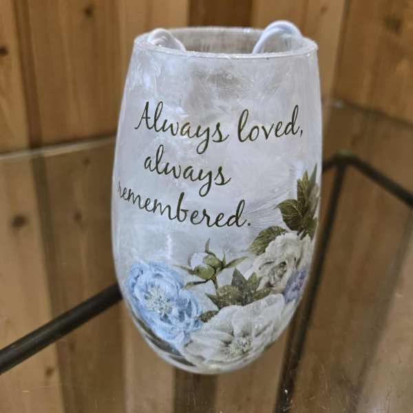 Decorative memorial candle holder with floral print and the words "Always loved, always remembered."