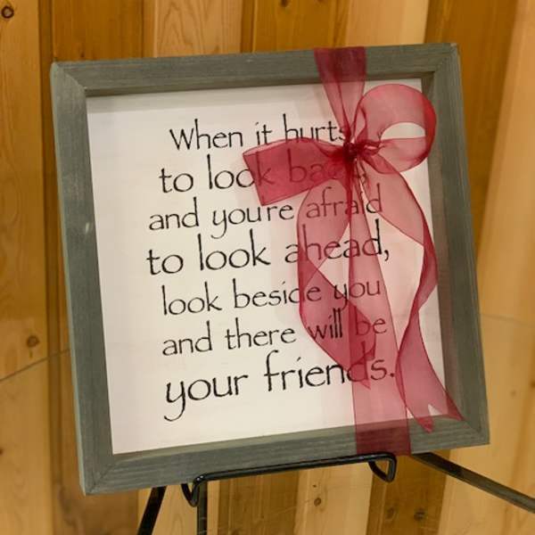 Framed quote sign with a pink ribbon bow