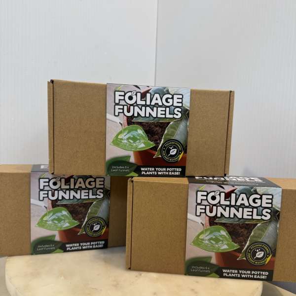 Three cardboard boxes of foliage funnels stacked on a round pedestal.